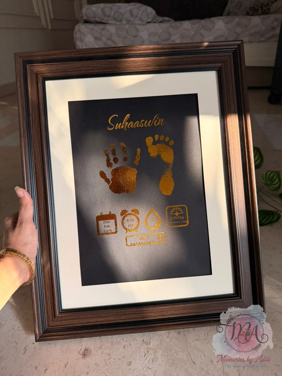 Suhaaswin foil keepsake, dark backdrop, bronze frame